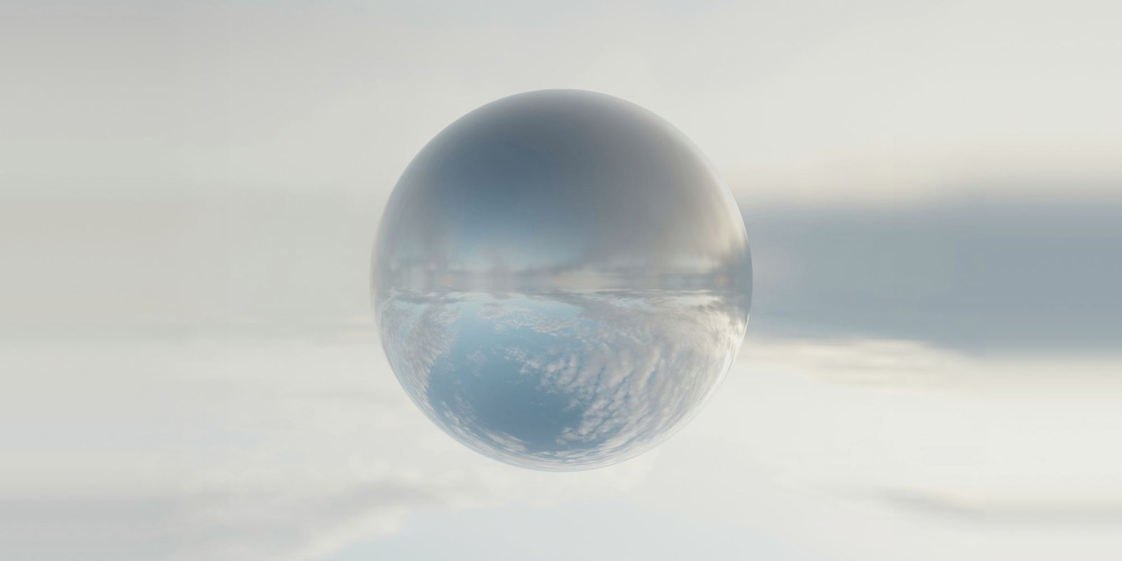 Une sphère miroir flotte au milieu des nuages.